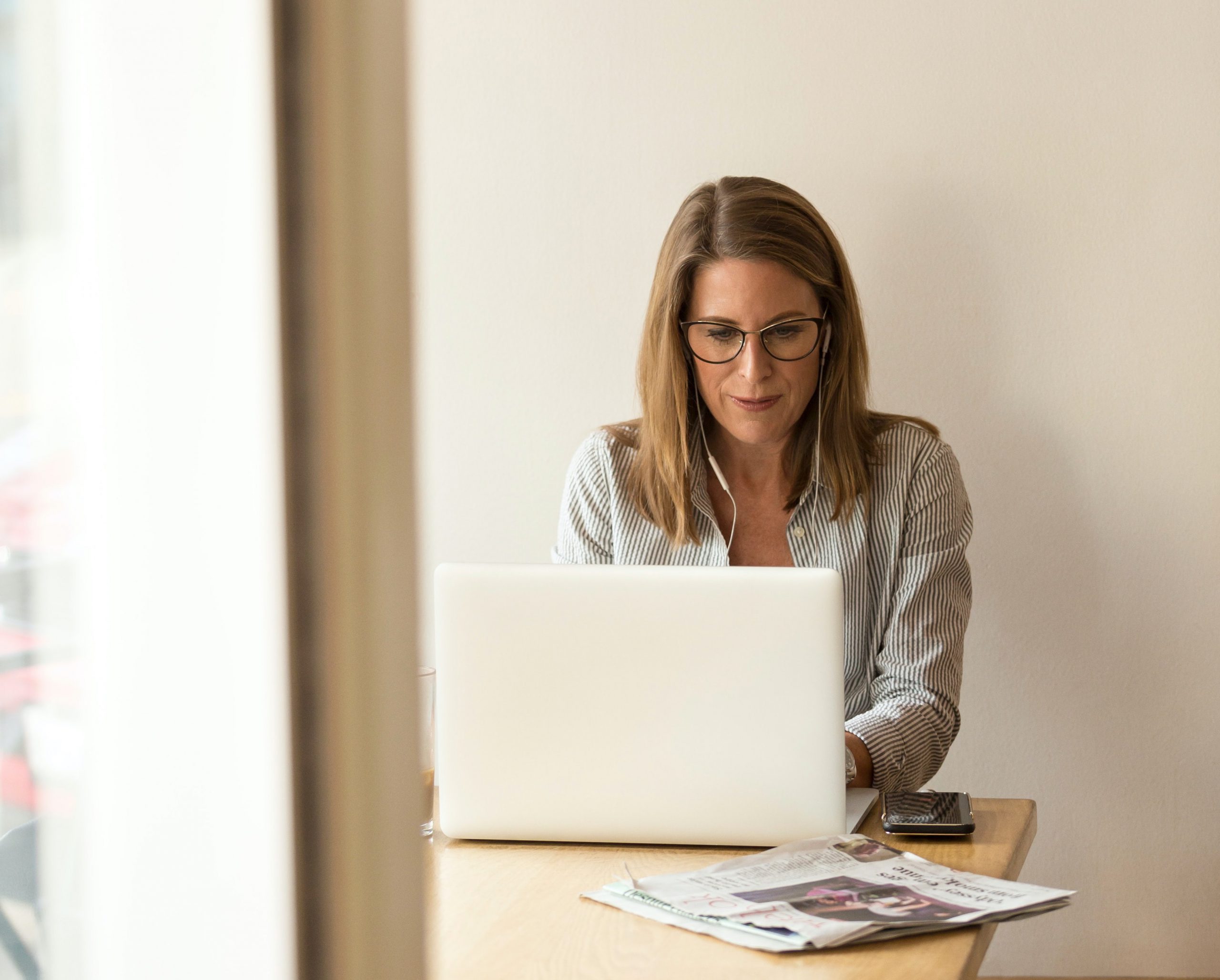 Woman working on laptop in an office.