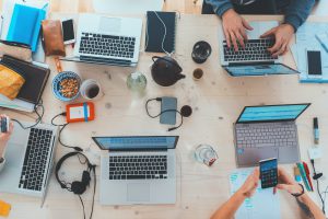 Laptops sit open on a table.