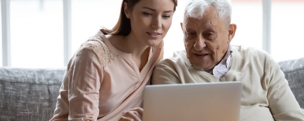 401k vs ira-min young woman and grandfather researching 401(k) vs IRA