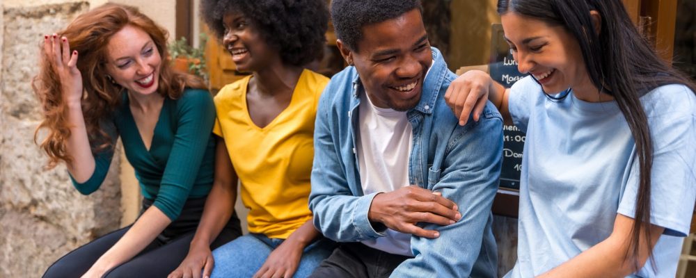 Multi-ethnic,Friends,In,A,Coffee,Shop,Sitting,In,The,Doorway