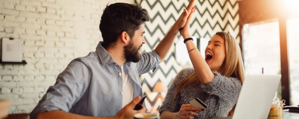 Portrait,Of,An,Excited,Young,Couple,Giving,High,Five,While Portrait,Of,An,Excited,Young,Couple,Giving,High,Five,While