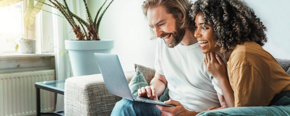 Multiracial,Young,Couple,Watching,Computer,Laptop,Sitting,On,The,Sofa Multiracial,Young,Couple,Watching,Computer,Laptop,Sitting,On,The,Sofa