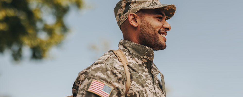 Happy,Young,Soldier,Smiling,Cheerfully,While,Standing,Outside,His,Home. Happy,Young,Soldier,Smiling,Cheerfully,While,Standing,Outside,His,Home.
