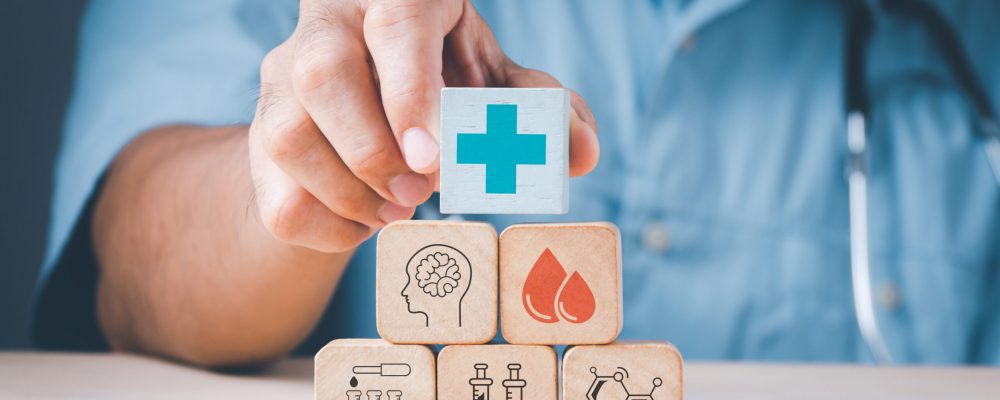Doctor’s,Hand,Stack,Woods,Block,Step,On,Table,With,Health Doctor's,Hand,Stack,Woods,Block,Step,On,Table,With,Health