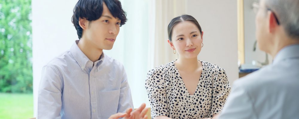 Young,Asian,Couple,Talking,With,A,Senior,Man.