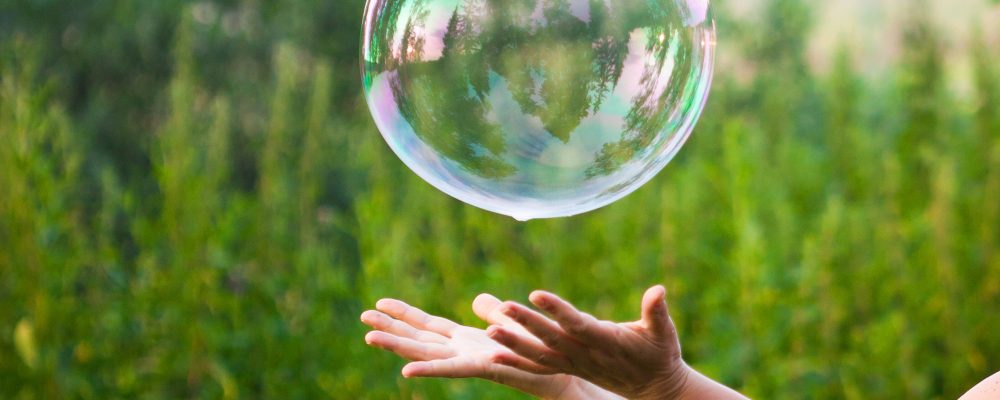 Hand,Catching,A,Soap,Bubble