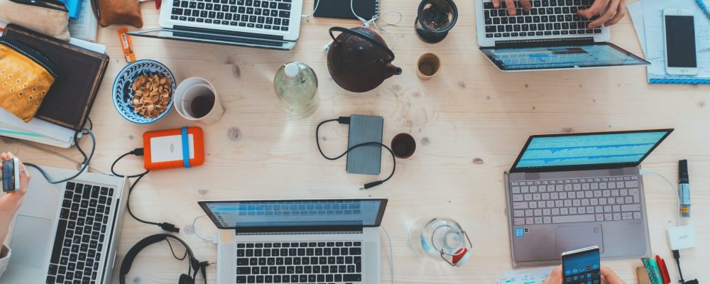 marvin-meyer-SYTO3xs06fU-unsplash Laptops sit open on a table.