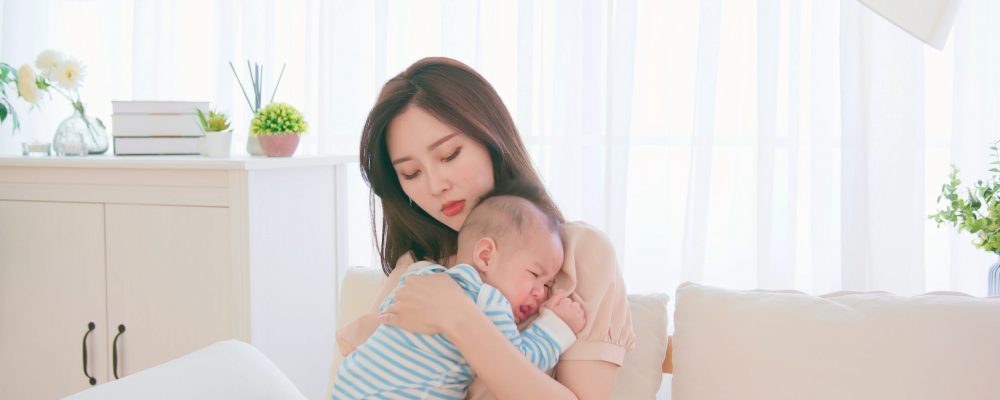 Authentic,Shot,Of,Asian,Mother,Holding,Her,Crying,Baby,On Authentic,Shot,Of,Asian,Mother,Holding,Her,Crying,Baby,On