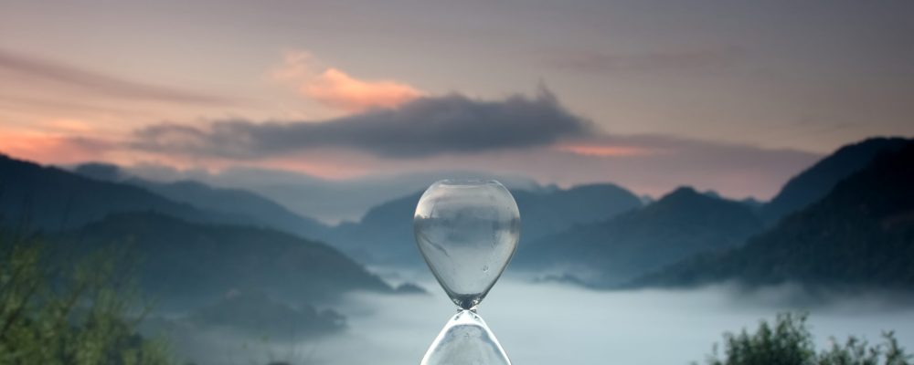 A,Hourglass,(with,Falling,Sand),On,A,Wooden,Wet,Table
