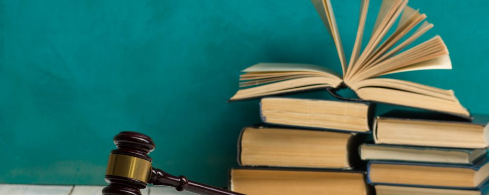 Law,Concept,-,Open,Law,Book,With,A,Wooden,Judges