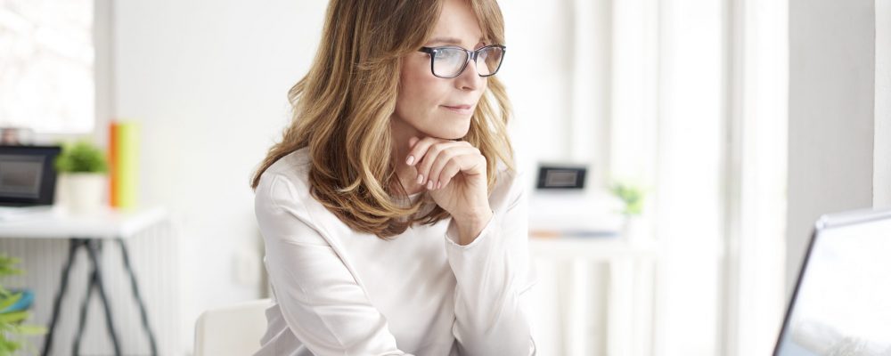 Shot,Of,An,Attractive,Mature,Businesswoman,Working,On,Laptop,In