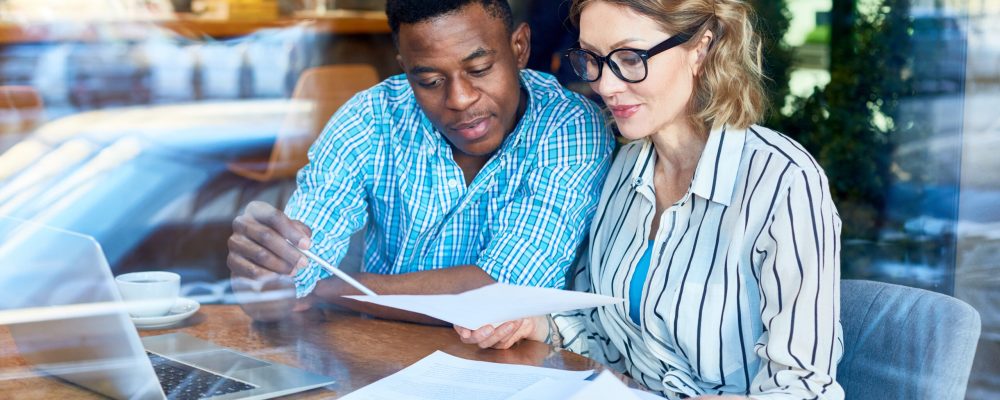 Confident,Bankers,Looking,Through,Financial,Papers,And,Reading,Their,Terms