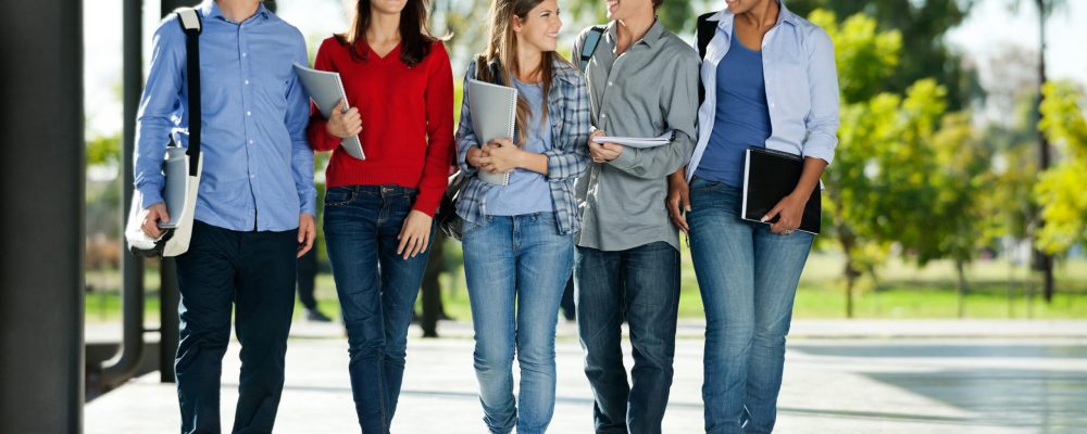 Full,Length,Of,Happy,College,Students,Walking,Together,On,Campus
