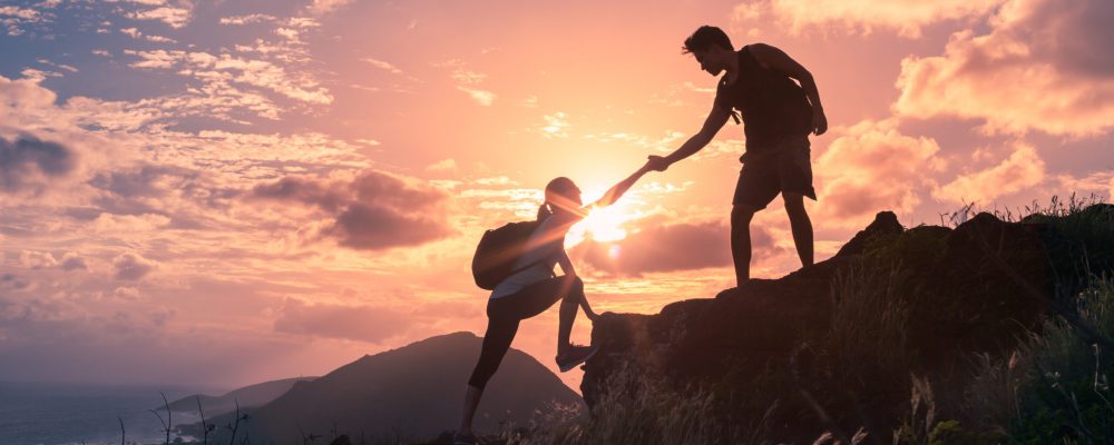 People,Helping,Each,Other,Hike,Up,A,Mountain,At,Sunrise. People,Helping,Each,Other,Hike,Up,A,Mountain,At,Sunrise.