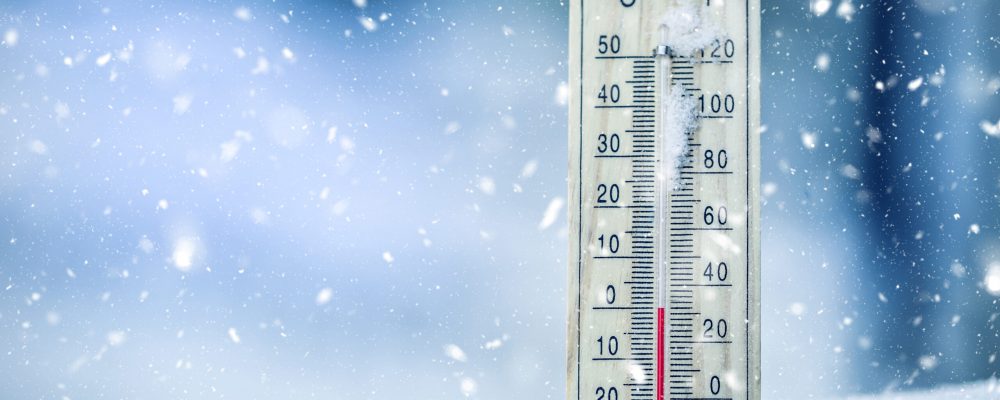 Thermometer,On,Snow,Shows,Low,Temperatures,In,Celsius,Or,Farenheit.
