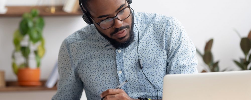 Focused,African,Business,Man,In,Headphones,Writing,Notes,In,Notebook Focused,African,Business,Man,In,Headphones,Writing,Notes,In,Notebook